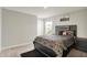 Stylish bedroom featuring a sleek black bed frame, a window view, and modern decor at 3719 Lexham Ct, Danville, IN 46122