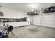 Spacious garage featuring ample storage and counter space with overhead shelving for organization at 3719 Lexham Ct, Danville, IN 46122