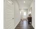 Bright hallway featuring wood floors, a console table, and access to the rest of the house at 3719 Lexham Ct, Danville, IN 46122