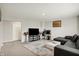 Spacious living room featuring a television, desk, and comfortable black sectional sofa at 3719 Lexham Ct, Danville, IN 46122