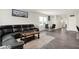 Comfortable living room featuring a large sectional sofa, wood floors, and natural light from the windows at 3719 Lexham Ct, Danville, IN 46122