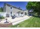 Large backyard featuring a spacious stone patio and lush green lawn with beautiful landscaping at 3829 Waycross Dr, Columbus, IN 47203