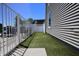 A charming side yard featuring pet-friendly artificial grass and secure fencing for added privacy at 3829 Waycross Dr, Columbus, IN 47203