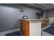 Basement bar includes a granite countertop, wood cabinets, and space for a television at 3829 Waycross Dr, Columbus, IN 47203