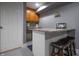 Basement bar area with wooden cabinets, granite countertops, and bar stool seating at 3829 Waycross Dr, Columbus, IN 47203