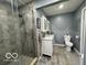 Modern bathroom with a glass-enclosed shower, double vanity, and contemporary fixtures at 3829 Waycross Dr, Columbus, IN 47203