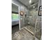 Beautiful bathroom with glass shower, mosaic tiling, and an open view to the bedroom at 3829 Waycross Dr, Columbus, IN 47203