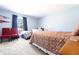 Bedroom featuring two beds, a window, blue walls, and carpeted floors at 3829 Waycross Dr, Columbus, IN 47203