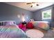 Shared bedroom featuring blue walls, two twin beds, and personalized decor at 3829 Waycross Dr, Columbus, IN 47203