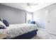 Modern bedroom with soft grey walls, a ceiling fan, and a window providing natural light at 3829 Waycross Dr, Columbus, IN 47203