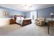 Spacious bedroom with wood furniture, ceiling fan, and plenty of natural light at 3829 Waycross Dr, Columbus, IN 47203