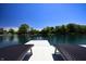 Inviting dock view with lounge chairs overlooking the tranquil lake and scenic waterfront homes on a sunny day at 3829 Waycross Dr, Columbus, IN 47203