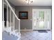 Bright foyer with staircase, tiled flooring, and glass-paneled front door at 3829 Waycross Dr, Columbus, IN 47203