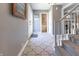 Welcoming foyer with decorative tiled flooring, coat rack, and staircase at 3829 Waycross Dr, Columbus, IN 47203