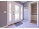 Welcoming foyer with tiled flooring, front door and coat rack at 3829 Waycross Dr, Columbus, IN 47203