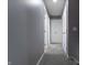 Carpeted hallway with neutral gray walls and white doors leading to various rooms at 3829 Waycross Dr, Columbus, IN 47203