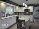 Modern kitchen featuring granite countertops, stainless steel appliances, and white cabinetry at 3829 Waycross Dr, Columbus, IN 47203