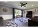 Bright and airy living room with a large window, ceiling fan, and comfortable seating area at 3829 Waycross Dr, Columbus, IN 47203