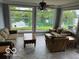 Inviting sunroom with abundant natural light, comfortable seating, and serene water views at 3829 Waycross Dr, Columbus, IN 47203