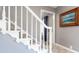Staircase with painted wooden banister and carpeted steps at 3829 Waycross Dr, Columbus, IN 47203