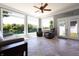 Relaxing sun room with lake view, three large windows, and comfortable seating at 3829 Waycross Dr, Columbus, IN 47203