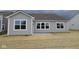 The backyard features a neutral vinyl siding and a concrete patio at 3998 Bozeman Way, Bargersville, IN 46106