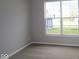 Cozy bedroom featuring a large window for natural light and plush carpeting at 3998 Bozeman Way, Bargersville, IN 46106