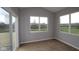 Light-filled sunroom features a glass sliding door and large windows with views of the backyard at 3998 Bozeman Way, Bargersville, IN 46106