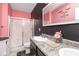 Modern bathroom featuring dual sinks, a spacious shower, and stylish pink and black accents at 410 Angelina Way, Avon, IN 46123