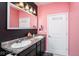Elegant bathroom with dual sinks, modern lighting, and stylish pink and black color scheme at 410 Angelina Way, Avon, IN 46123