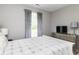 Comfortable bedroom featuring a window with curtains, a dresser with a TV, and a lamp at 410 Angelina Way, Avon, IN 46123