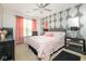 Stylish bedroom featuring unique wallpaper, a ceiling fan, and elegant decor at 410 Angelina Way, Avon, IN 46123