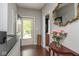 Inviting foyer with hardwood floors, elegant mirror, and views to the home's exterior at 410 Angelina Way, Avon, IN 46123