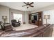 Inviting living room with leather seating, built-in entertainment center, and soft natural light at 410 Angelina Way, Avon, IN 46123