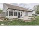 Backyard featuring a sunroom, patio, lush green grass, and exterior details at 4675 Walker St, Greenwood, IN 46143