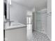 Stylish bathroom featuring a double vanity, glass-enclosed shower, and decorative tile flooring at 4675 Walker St, Greenwood, IN 46143