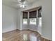 Inviting bedroom with hardwood floors, natural light from the bay window, and ceiling fan at 4675 Walker St, Greenwood, IN 46143