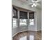 Well-lit bedroom features a ceiling fan, a bay window, and hardwood flooring throughout at 4675 Walker St, Greenwood, IN 46143