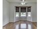 Bright bedroom boasts hardwood floors, a ceiling fan, and plenty of natural light at 4675 Walker St, Greenwood, IN 46143