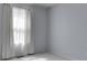 Bright bedroom featuring neutral carpet and light blue walls, illuminated by natural light from a window at 4675 Walker St, Greenwood, IN 46143