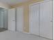 Bedroom with three large closets and neutral carpet at 4675 Walker St, Greenwood, IN 46143