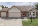 Charming home featuring a three-car garage, brick accents, and a vibrant red front door at 4675 Walker St, Greenwood, IN 46143
