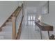 Inviting hallway featuring a staircase, stylish console table, and access to living area at 4675 Walker St, Greenwood, IN 46143