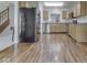 Open kitchen boasts stainless steel appliances, hardwood floors, and ample cabinet space at 4675 Walker St, Greenwood, IN 46143