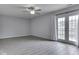 Spacious living room featuring modern flooring and a ceiling fan, with sliding glass doors to the backyard at 4675 Walker St, Greenwood, IN 46143