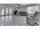 Spacious living room with hardwood floors, ceiling fan, and a comfortable gray sofa at 4675 Walker St, Greenwood, IN 46143
