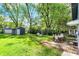 A spacious backyard with a patio, an outdoor table and chairs, and a detached garage for entertaining at 5015 Carrollton Ave, Indianapolis, IN 46205