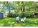 Green backyard with a fire pit and lawn at 5015 Carrollton Ave, Indianapolis, IN 46205