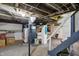Unfinished basement with laundry area, exposed ceiling, and concrete floor at 5015 Carrollton Ave, Indianapolis, IN 46205