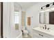 Bathroom featuring modern fixtures, a tub, and natural light at 5015 Carrollton Ave, Indianapolis, IN 46205